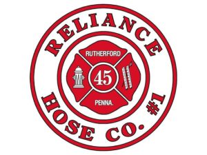 Red and white logo of Reliance Hose Co. #1. It features a hydrant, ladder, and "Rutherford 45 Penna" in the center, encircled by the company name.